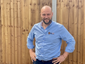 Man in smart blue Biochem Pest Control shirt smiling at the camera